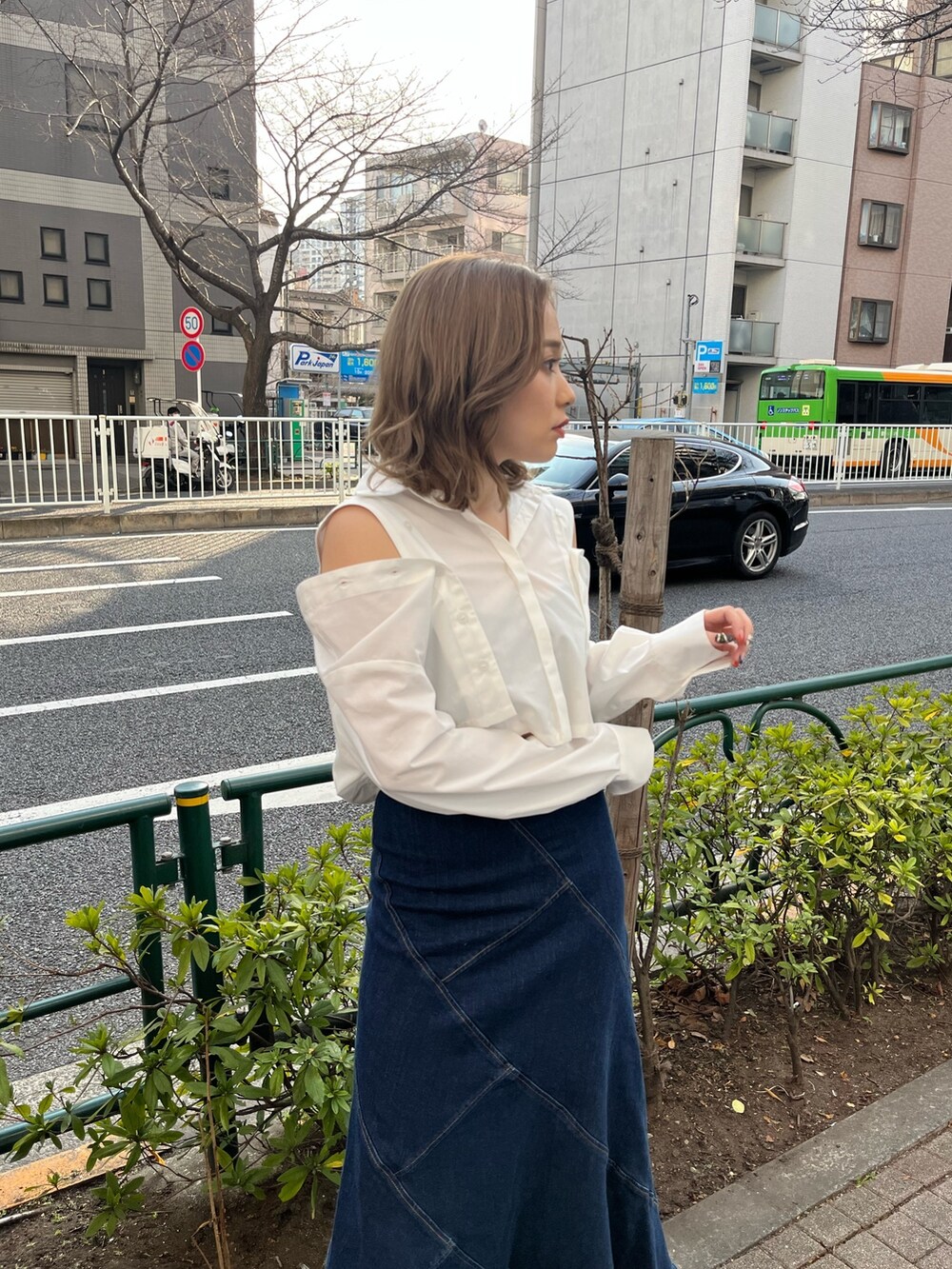 ホワイト系のシャツ/ブラウス、ブルー系のデニムスカート、ブラック系のサンダルを着用したレディースの春コーディネートの4枚目の写真