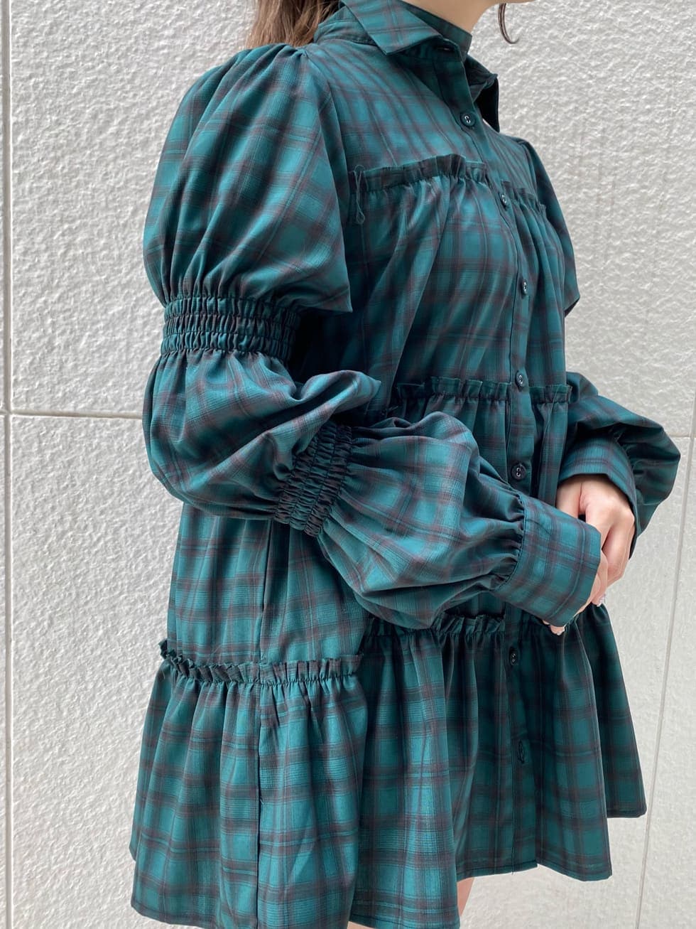 グリーン系のシャツ/ブラウス、ブラック系のブーツを着用したレディースの冬コーディネートの4枚目の写真