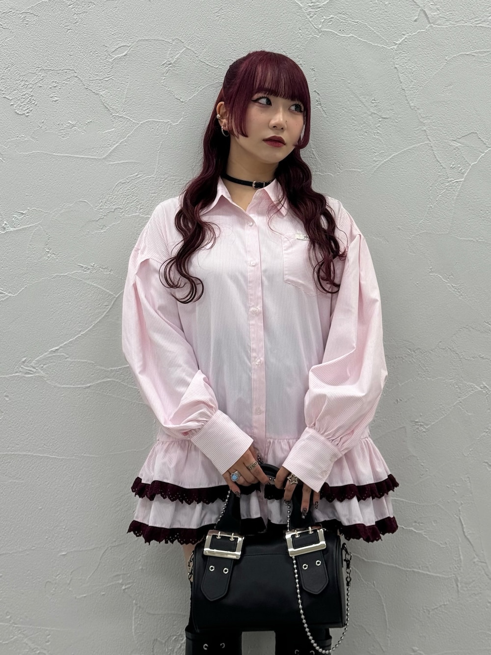 ピンク系のシャツ/ブラウス、ブラック系のボストンバッグ、ブラック系のブーツを着用したレディースの秋コーディネートの4枚目の写真