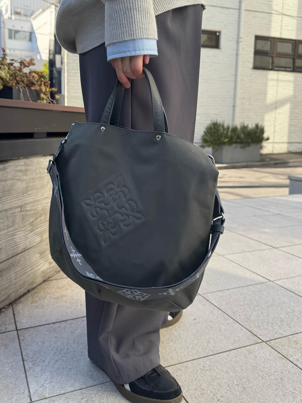 グレー系のトートバッグを着用したレディースの冬コーディネートの2枚目の写真