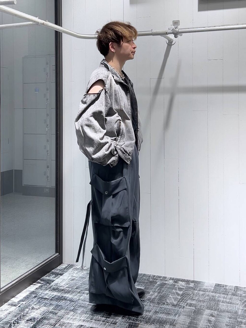 ブラック系のドレスシューズ、ブラック系のTシャツ/カットソー、グレー系のブルゾンを着用したメンズの夏コーディネートの3枚目の写真