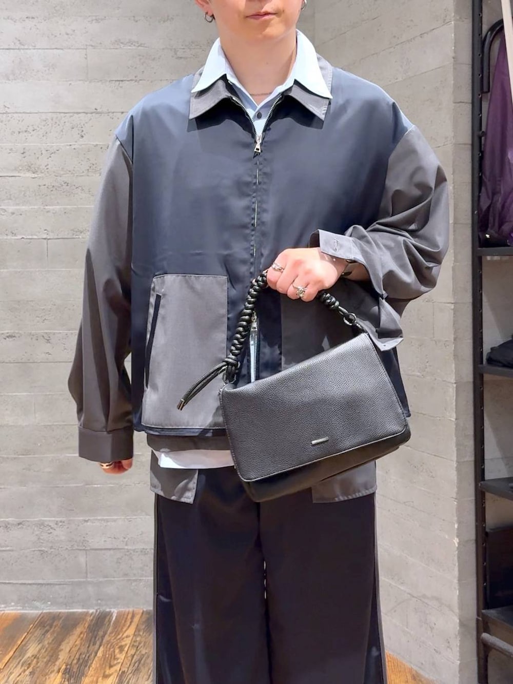 ブラック系のローファー、ブラック系のショルダーバッグ、グレー系のスラックスを着用したメンズの夏コーディネートの5枚目の写真