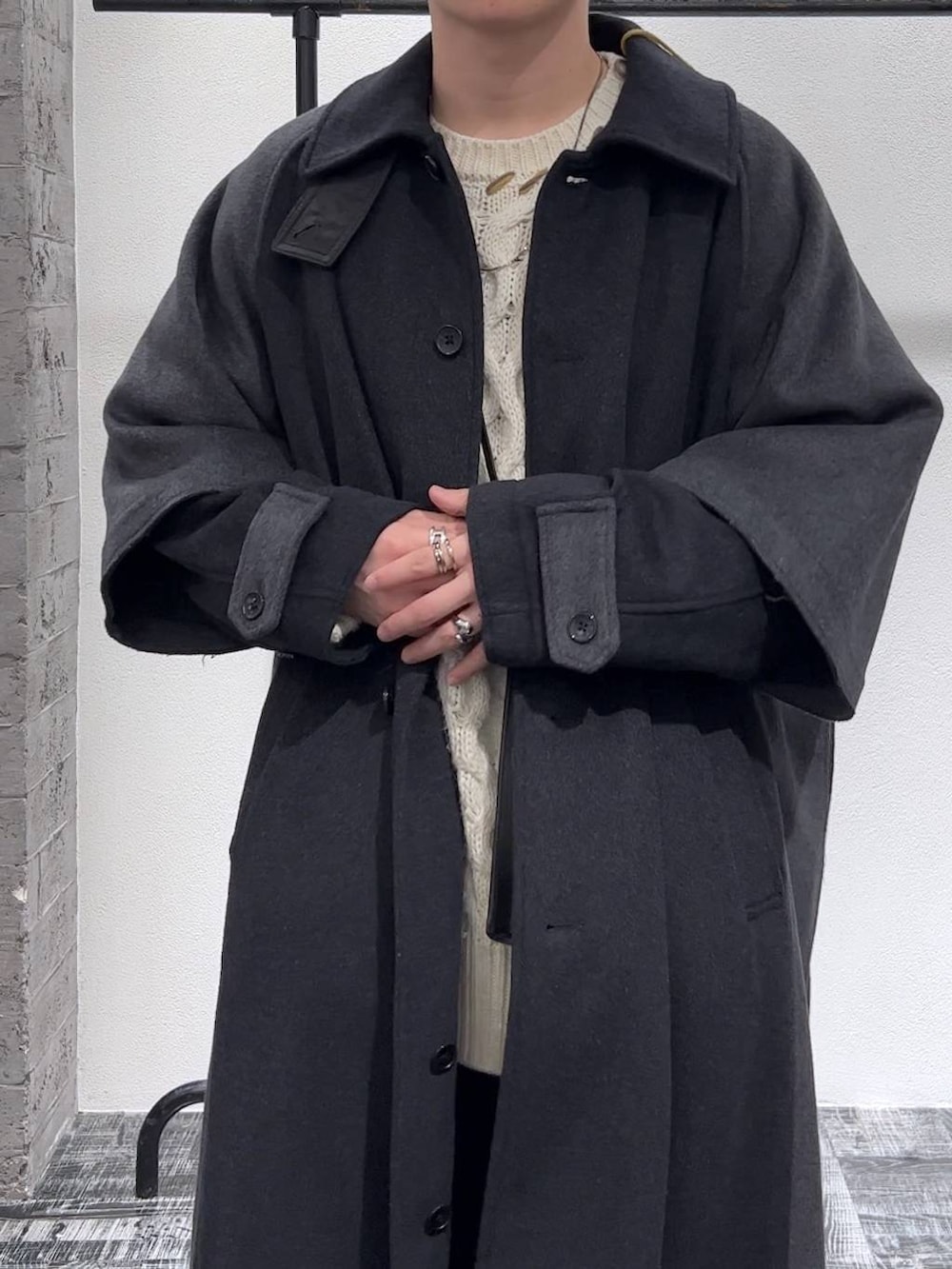 ブラック系のドレスシューズ、ブルー系のデニムパンツ、グレー系のトレンチコートを着用したメンズの秋コーディネートの5枚目の写真