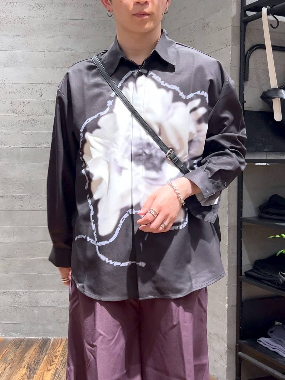 ブラック系のサンダル、ブラック系のショルダーバッグ、パープル系のスラックスを着用したメンズの夏コーディネートの5枚目の写真