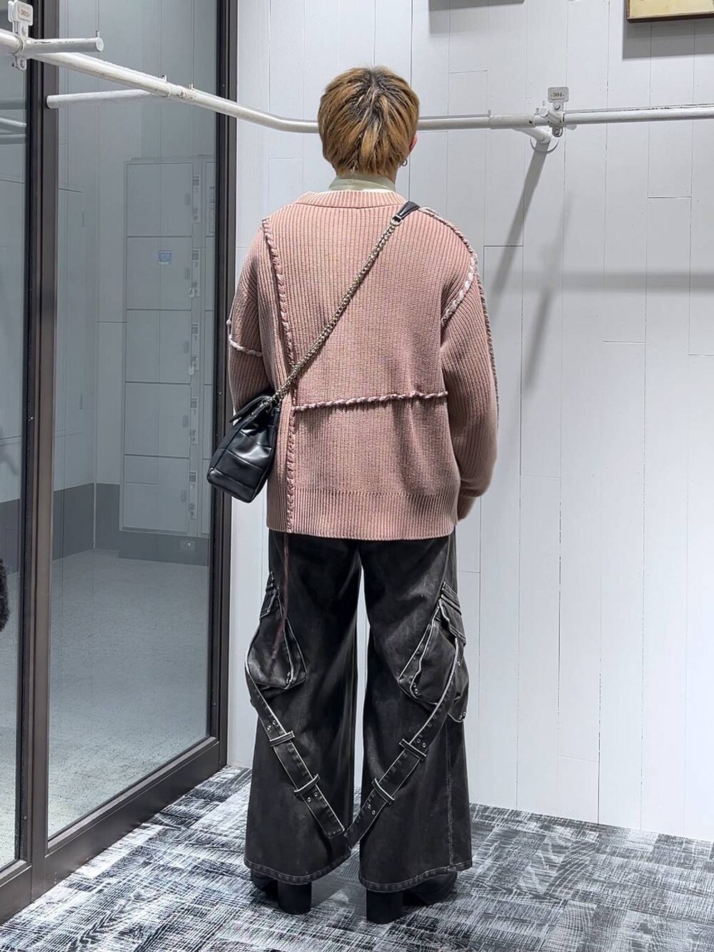 グレー系のカーゴパンツ、ブラック系のショルダーバッグ、ピンク系のカーディガン/ボレロを着用したメンズの冬コーディネートの3枚目の写真