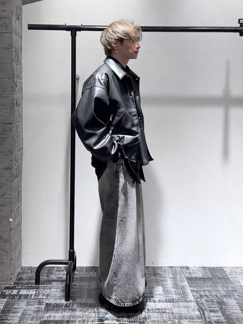 ブラック系のスニーカー、ブラック系のブルゾン、ブラック系のショルダーバッグを着用したメンズの冬コーディネートの3枚目の写真