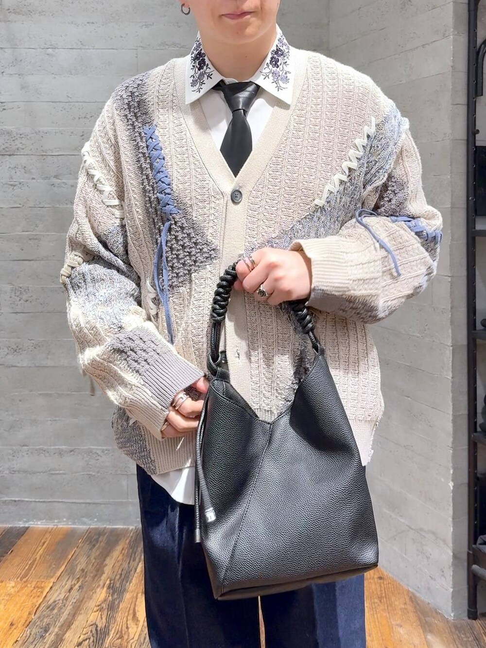 ブルー系のデニムパンツ、ホワイト系のシャツ/ブラウス、ブラック系のトートバッグを着用したメンズの秋コーディネートの5枚目の写真