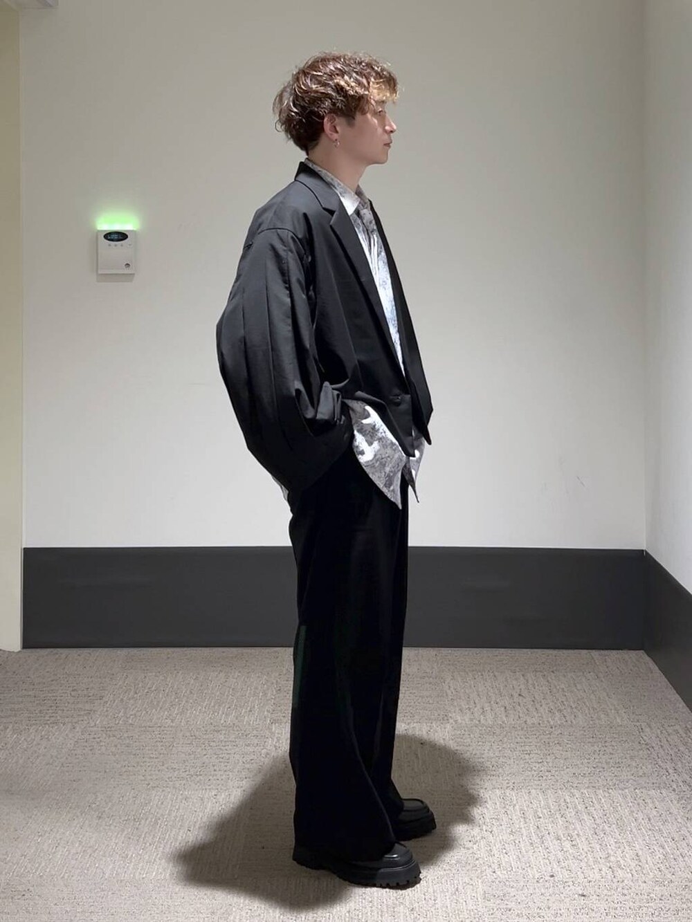 ブラック系のスラックス、ブラック系のドレスシューズ、ブラック系のテーラードジャケットを着用したメンズの秋コーディネートの2枚目の写真