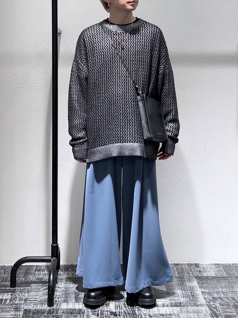 ブラック系のTシャツ/カットソー、グレー系のニット/セーター、ブラック系のショルダーバッグを着用したメンズの春コーディネートの2枚目の写真