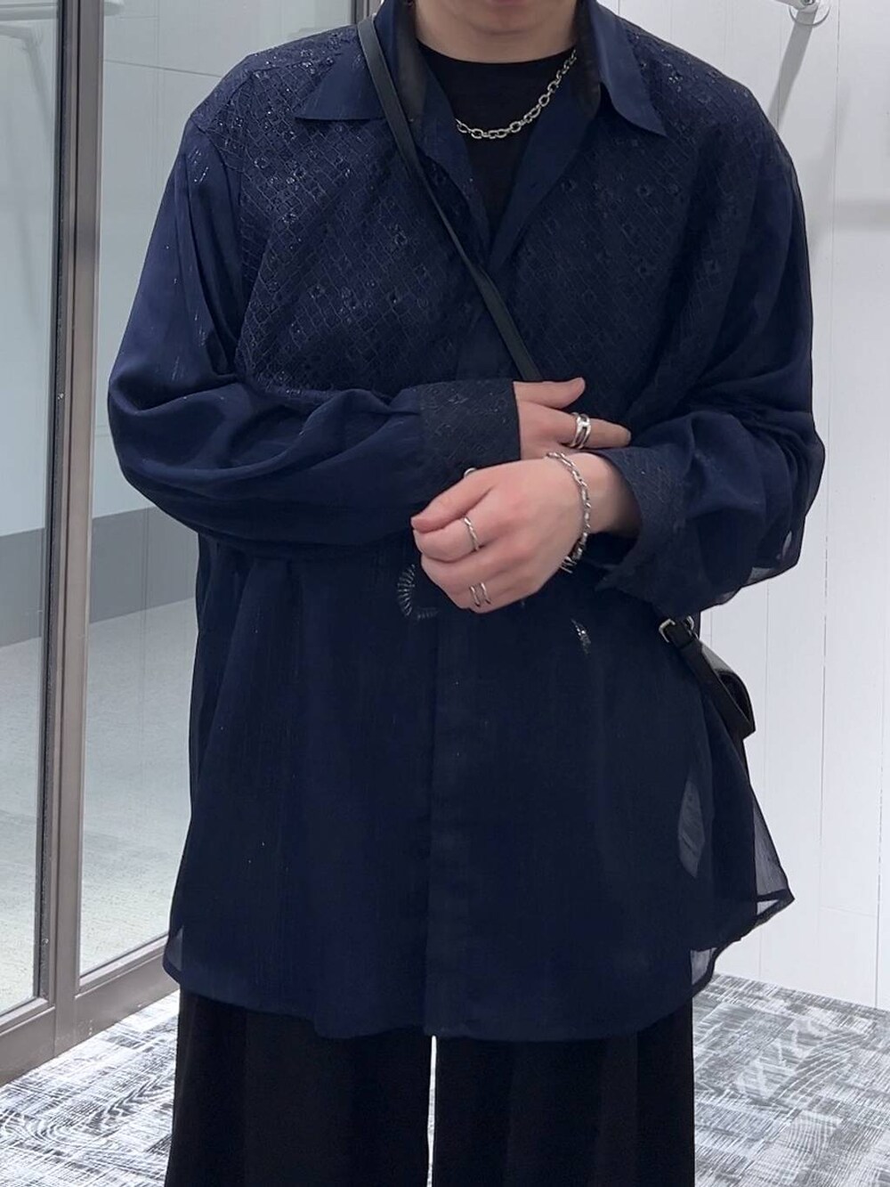 ブラック系のTシャツ/カットソー、ブラック系のショルダーバッグ、ブラック系のスラックスを着用したメンズの春コーディネートの5枚目の写真