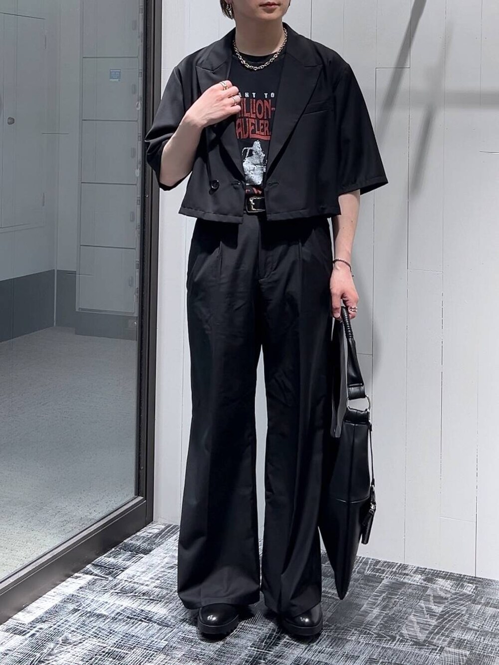 ブラック系のドレスシューズ、ブラック系のトートバッグ、ブラック系のTシャツ/カットソーを着用したメンズの春コーディネートの2枚目の写真