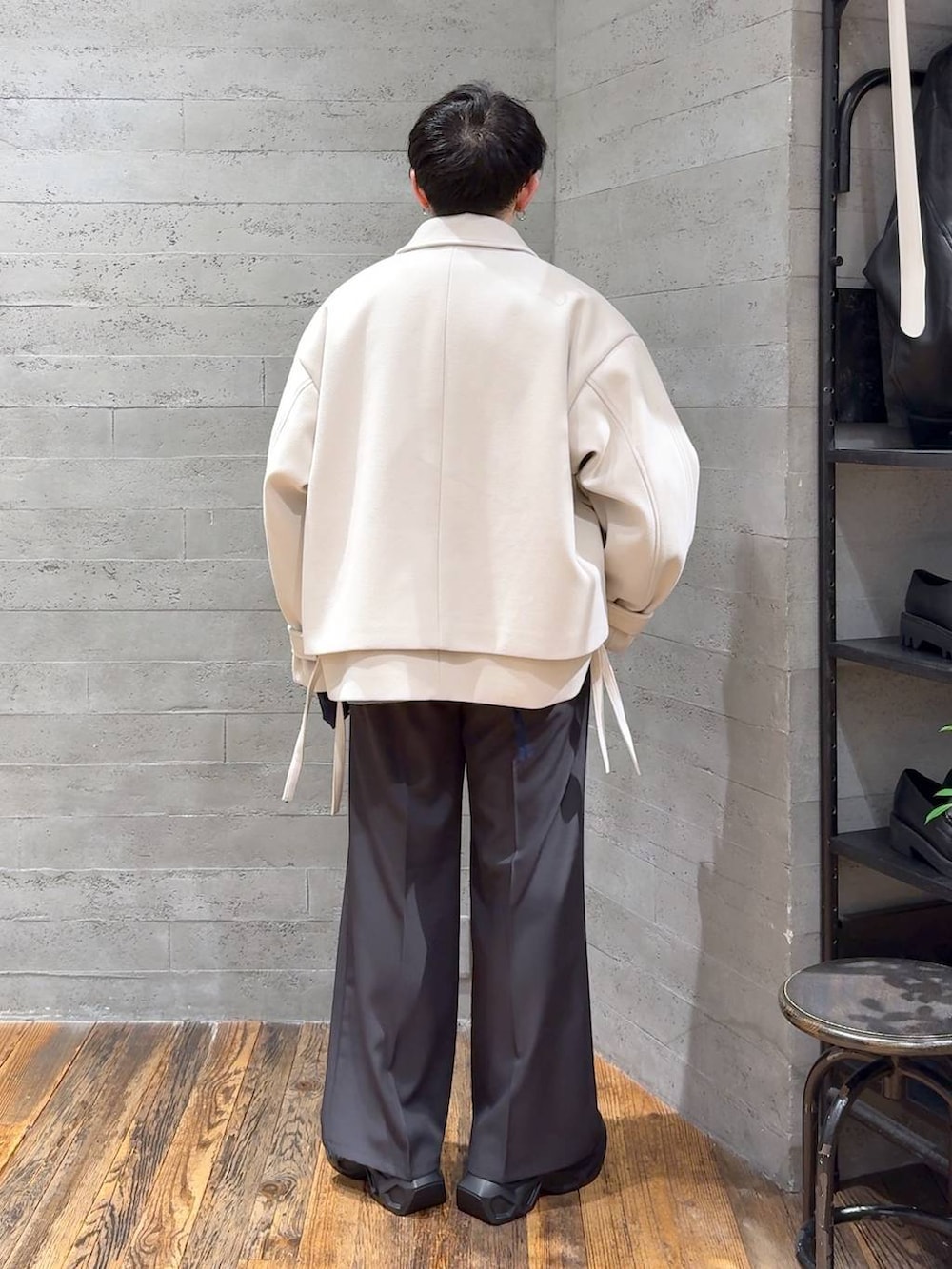 ホワイト系のブルゾン、ブラック系のスニーカー、ブラック系のTシャツ/カットソーを着用したメンズの秋コーディネートの3枚目の写真