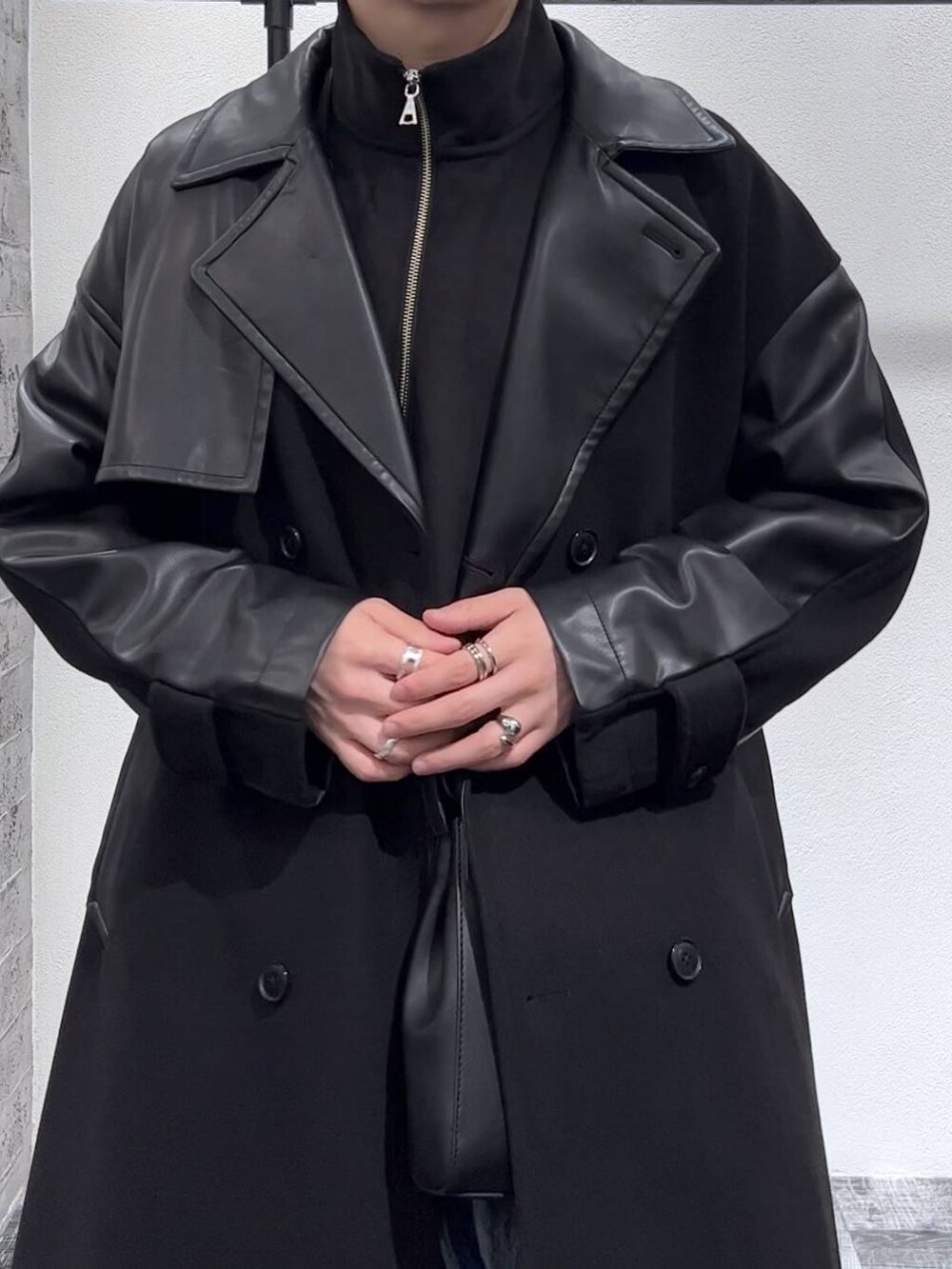 ブラック系のトレンチコート、ブラック系のショルダーバッグ、ブラック系のスウェットを着用したメンズの秋コーディネートの5枚目の写真