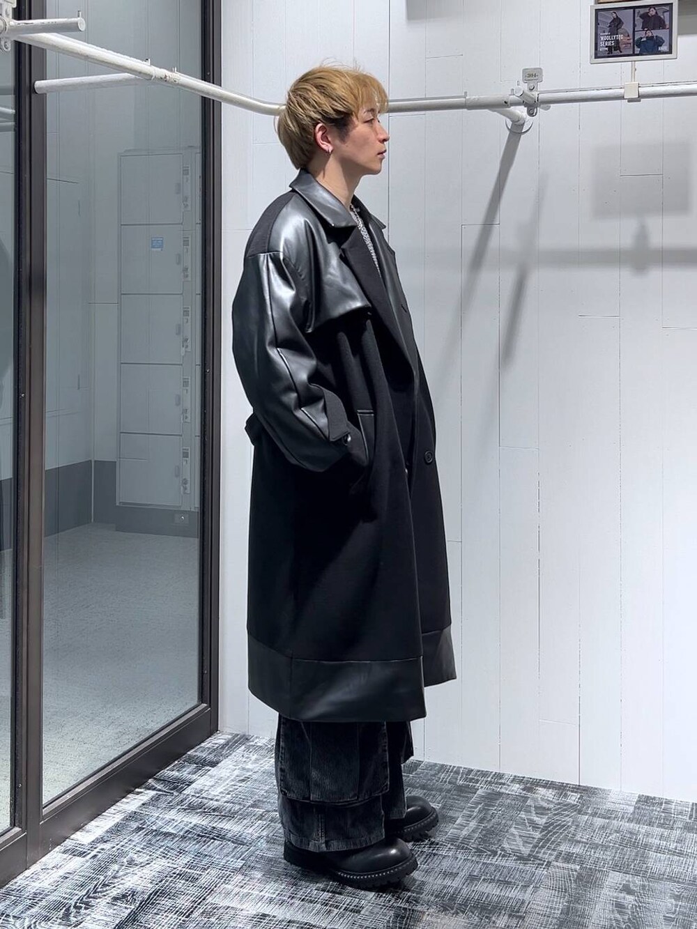 ブラック系のトレンチコート、ブラック系のその他シューズ、グレー系のニット/セーターを着用したメンズの秋コーディネートの2枚目の写真