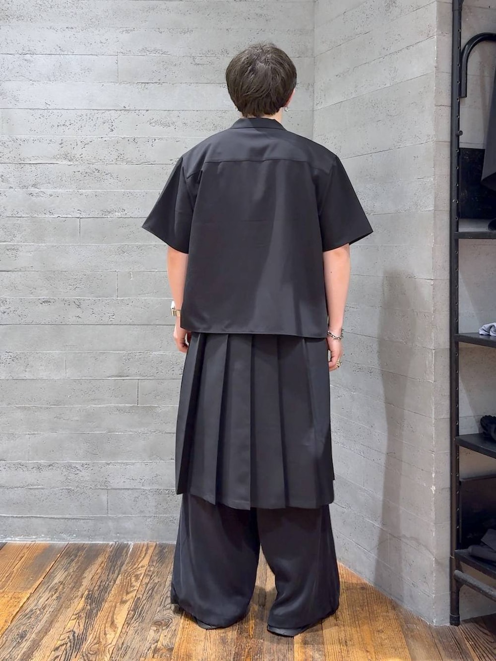 ブラック系のスラックス、ブラック系のスカート、ホワイト系のTシャツ/カットソーを着用したメンズの夏コーディネートの3枚目の写真