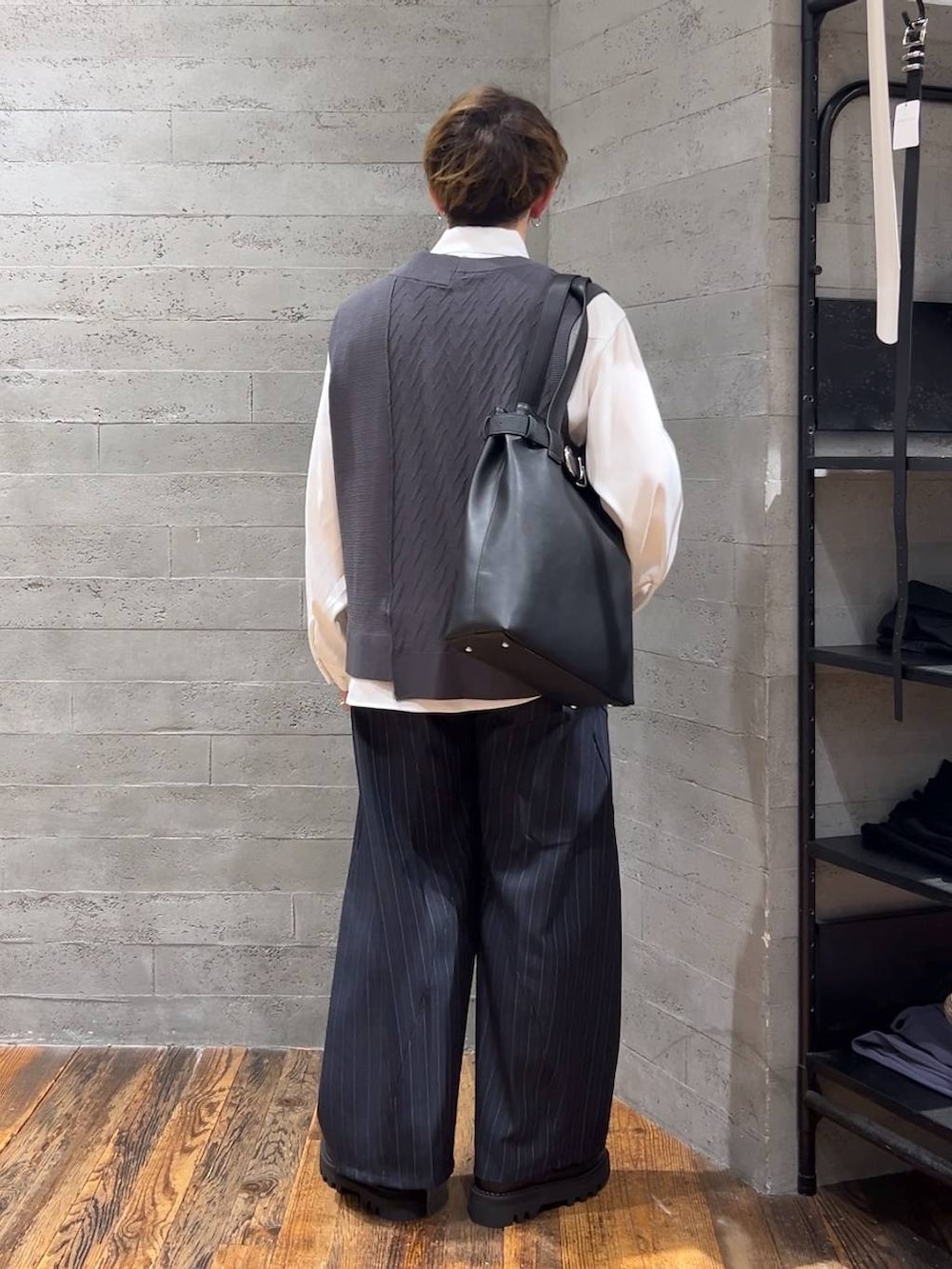 ブラック系のトートバッグ、ブラック系のドレスシューズ、グレー系のベストを着用したメンズの夏コーディネートの3枚目の写真