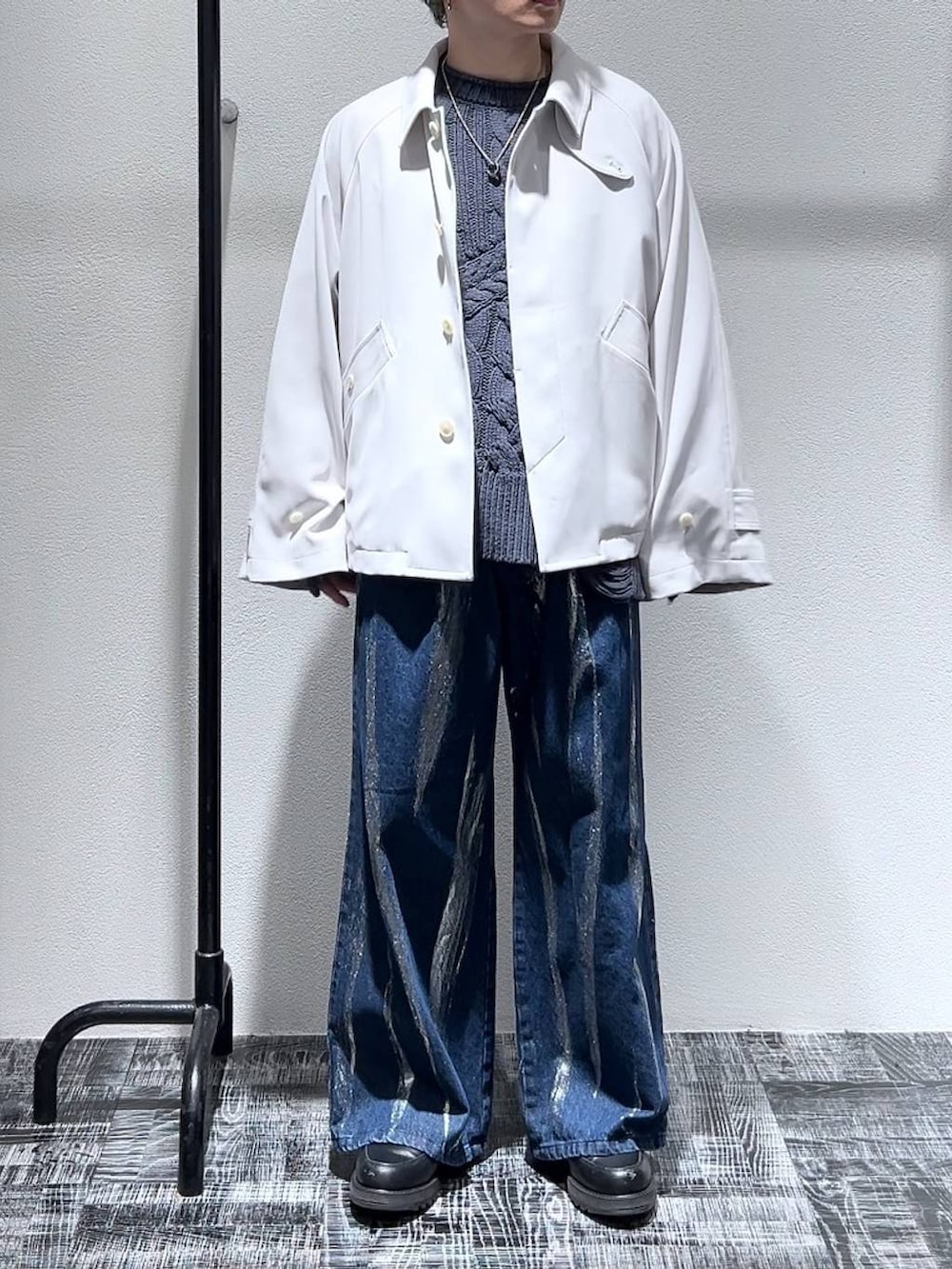 ブラック系のドレスシューズ、ホワイト系のブルゾン、ブルー系のデニムパンツを着用したメンズの冬コーディネートの2枚目の写真