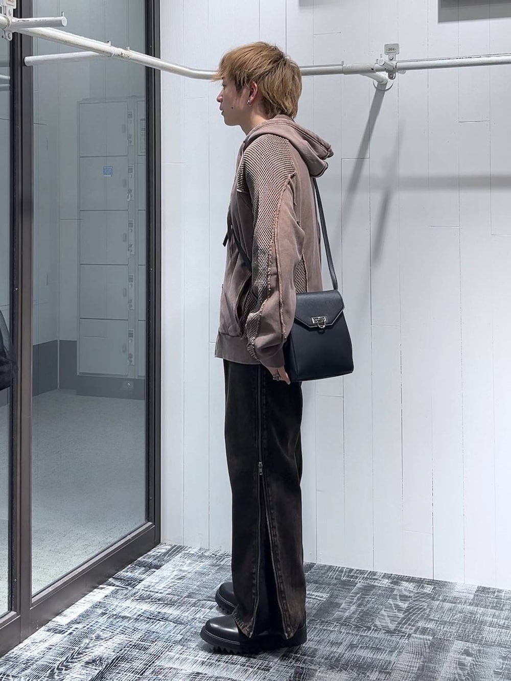 オレンジ系のデニムパンツ、ブラウン系のパーカー、ブラック系のドレスシューズを着用したメンズの春コーディネートの4枚目の写真