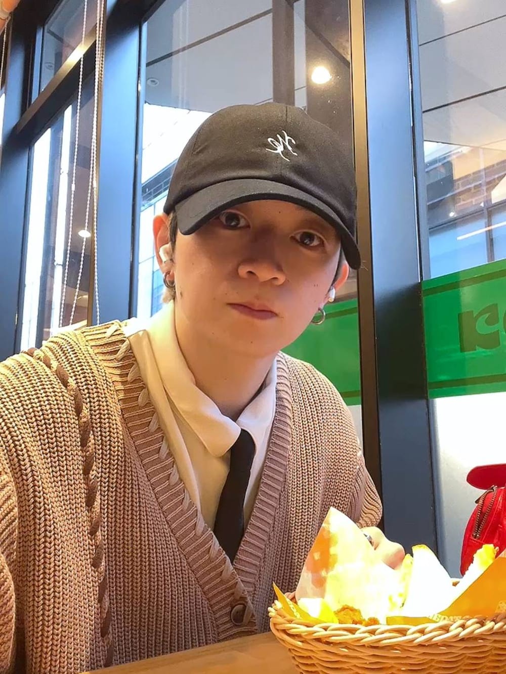 ホワイト系のシャツ/ブラウス、ブルー系のデニムパンツ、レッド系のショルダーバッグを着用したメンズの冬コーディネートの3枚目の写真