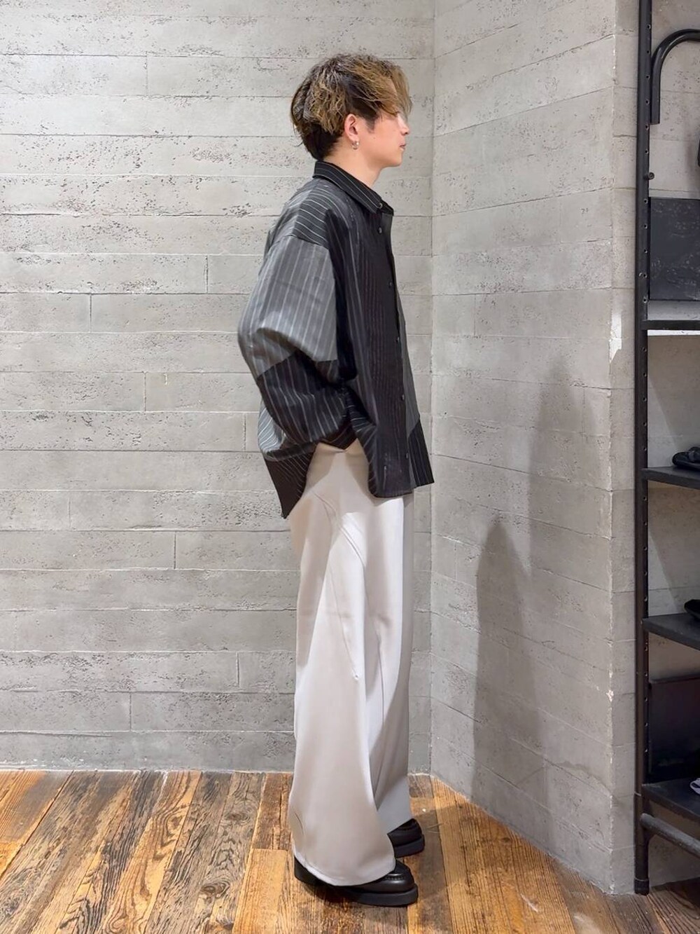 ブラック系のローファー、グレー系のスラックス、ブラック系のTシャツ/カットソーを着用したメンズの夏コーディネートの2枚目の写真