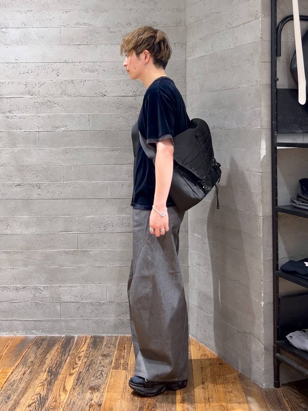 グレー系のデニムパンツ、ブラック系のサンダル、ブラック系のメッセンジャーバッグを着用したメンズの夏コーディネートの4枚目の写真