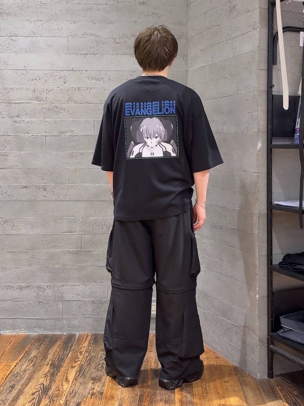ブラック系のTシャツ/カットソー、ブラック系のサンダル、ブラック系のカーゴパンツを着用したメンズの夏コーディネートの3枚目の写真