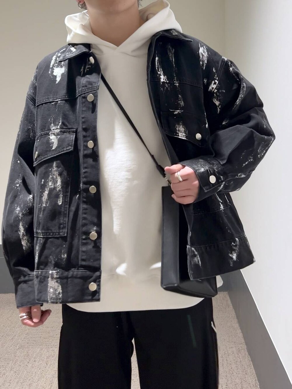 ブラック系のショルダーバッグ、ブラック系のドレスシューズ、ブルー系のスラックスを着用したメンズの冬コーディネートの5枚目の写真