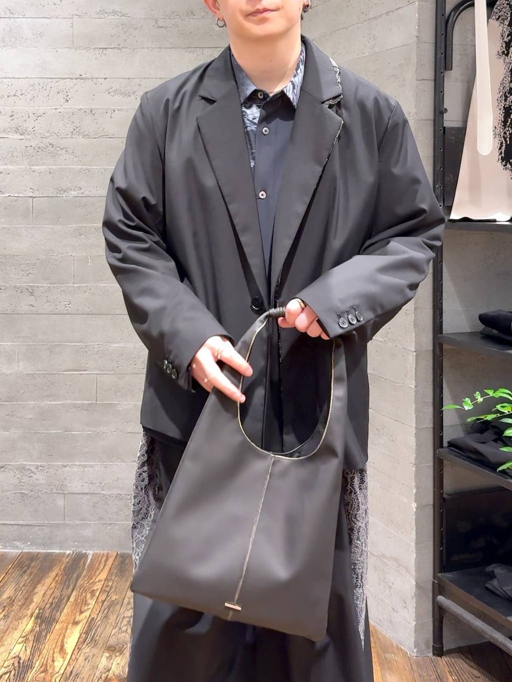 ブラック系のトートバッグ、ブラック系のブーツ、ブラック系のその他パンツを着用したメンズの冬コーディネートの5枚目の写真