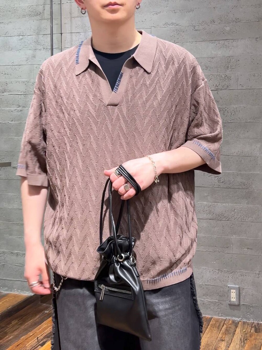 ブラック系のサンダル、ブラック系のデニムパンツ、ブラウン系のポロシャツを着用したメンズの夏コーディネートの5枚目の写真