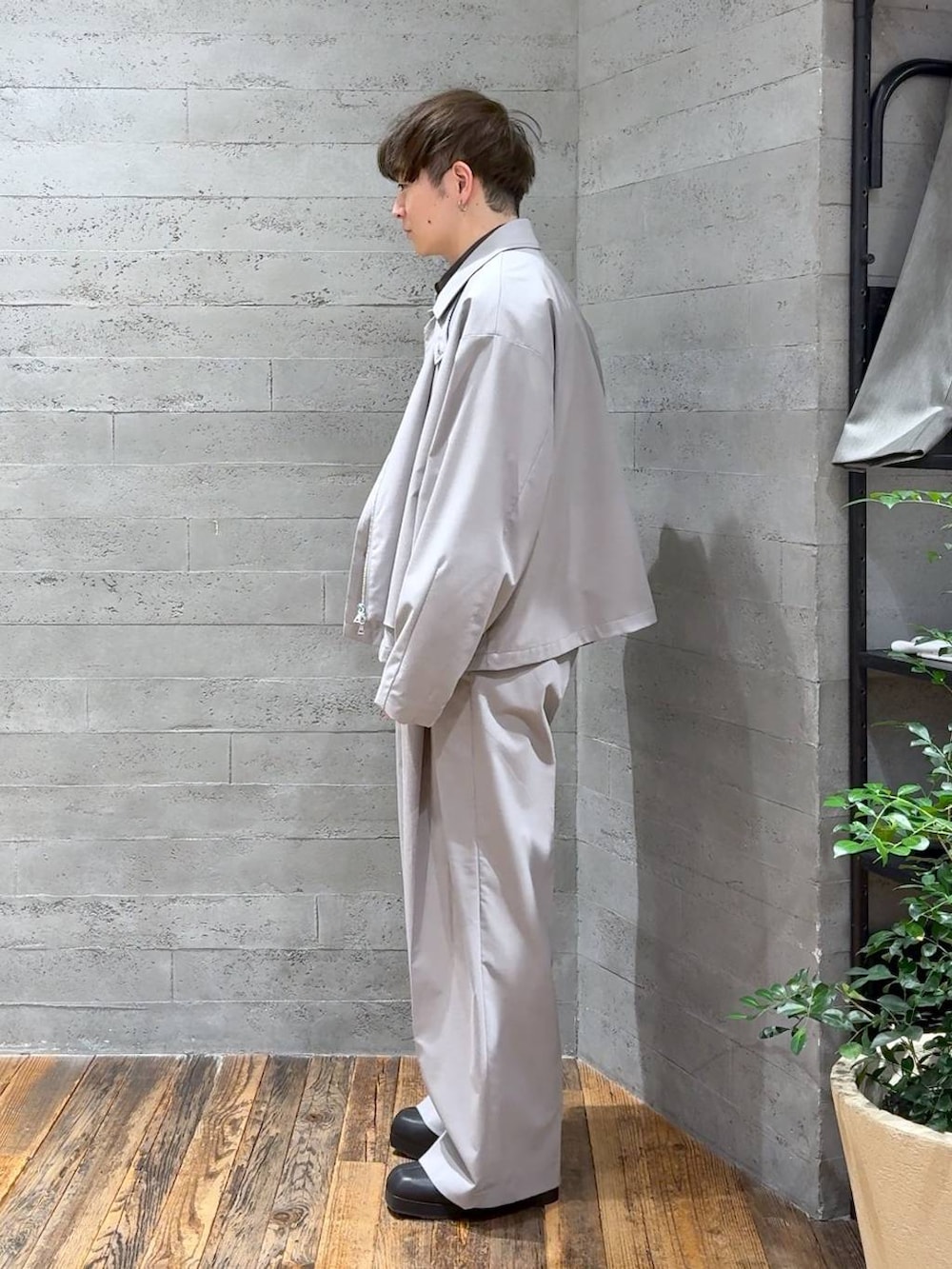 ブラック系のブーツ、グレー系のスラックス、グレー系のブルゾンを着用したメンズの冬コーディネートの4枚目の写真