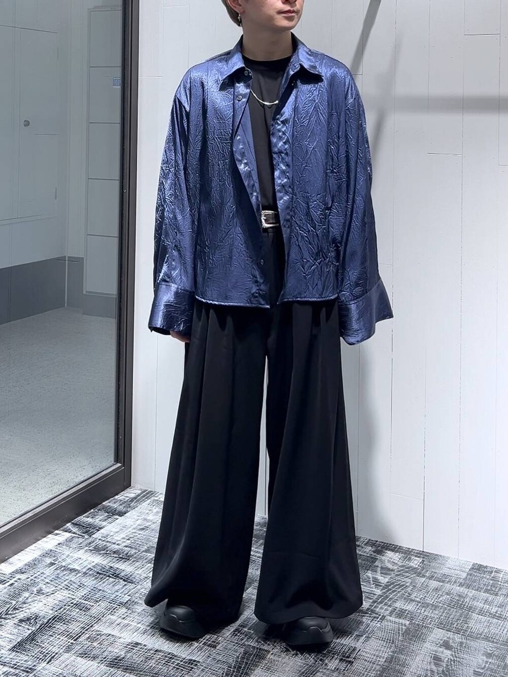 ブルー系のシャツ/ブラウス、ブラック系のTシャツ/カットソー、ブラック系のスラックスを着用したメンズの春コーディネートの2枚目の写真