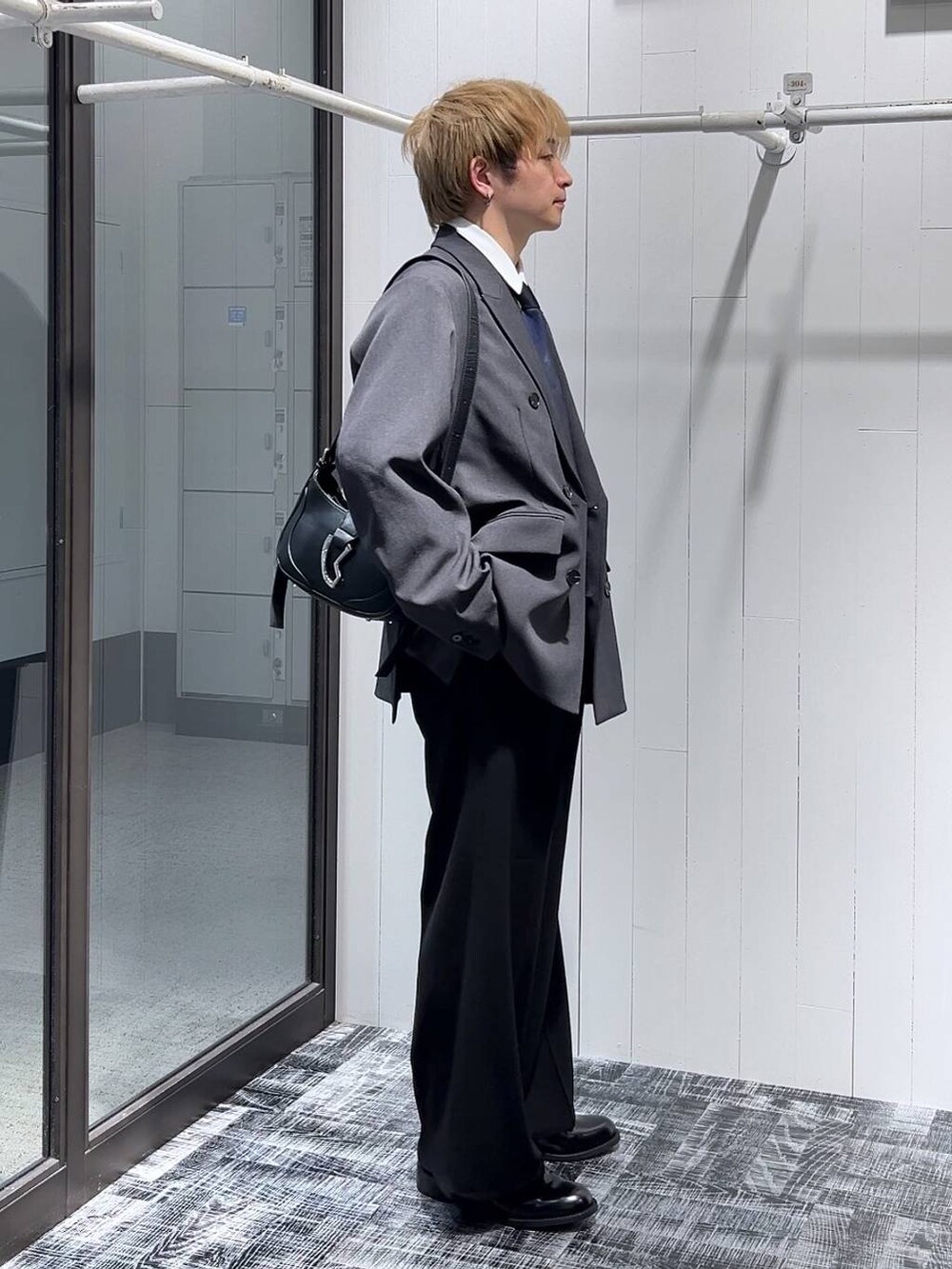ホワイト系のシャツ/ブラウス、ブラック系のスラックス、ブラック系のドレスシューズを着用したメンズの冬コーディネートの2枚目の写真