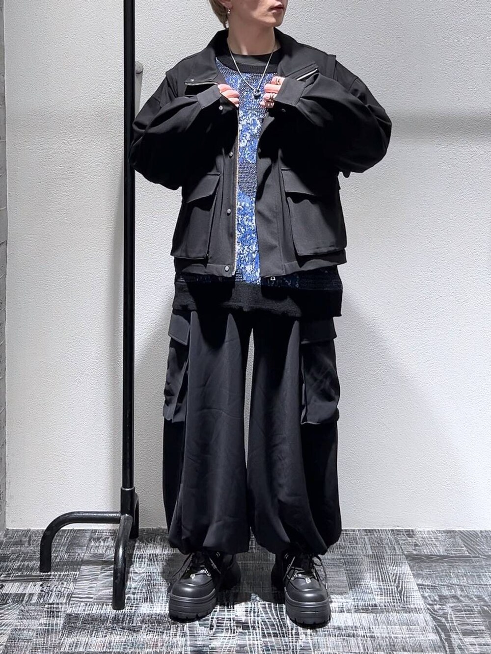 ブラック系のスニーカー、ブラック系のブルゾン、ブラック系のカーゴパンツを着用したメンズの春コーディネートの2枚目の写真