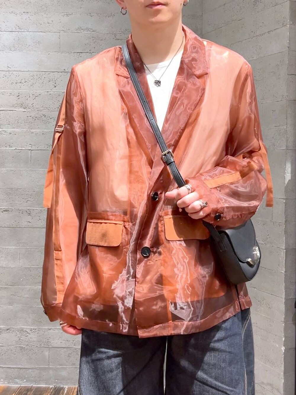 ブルー系のデニムパンツ、ブラック系のサンダル、ブラック系のショルダーバッグを着用したメンズの夏コーディネートの5枚目の写真