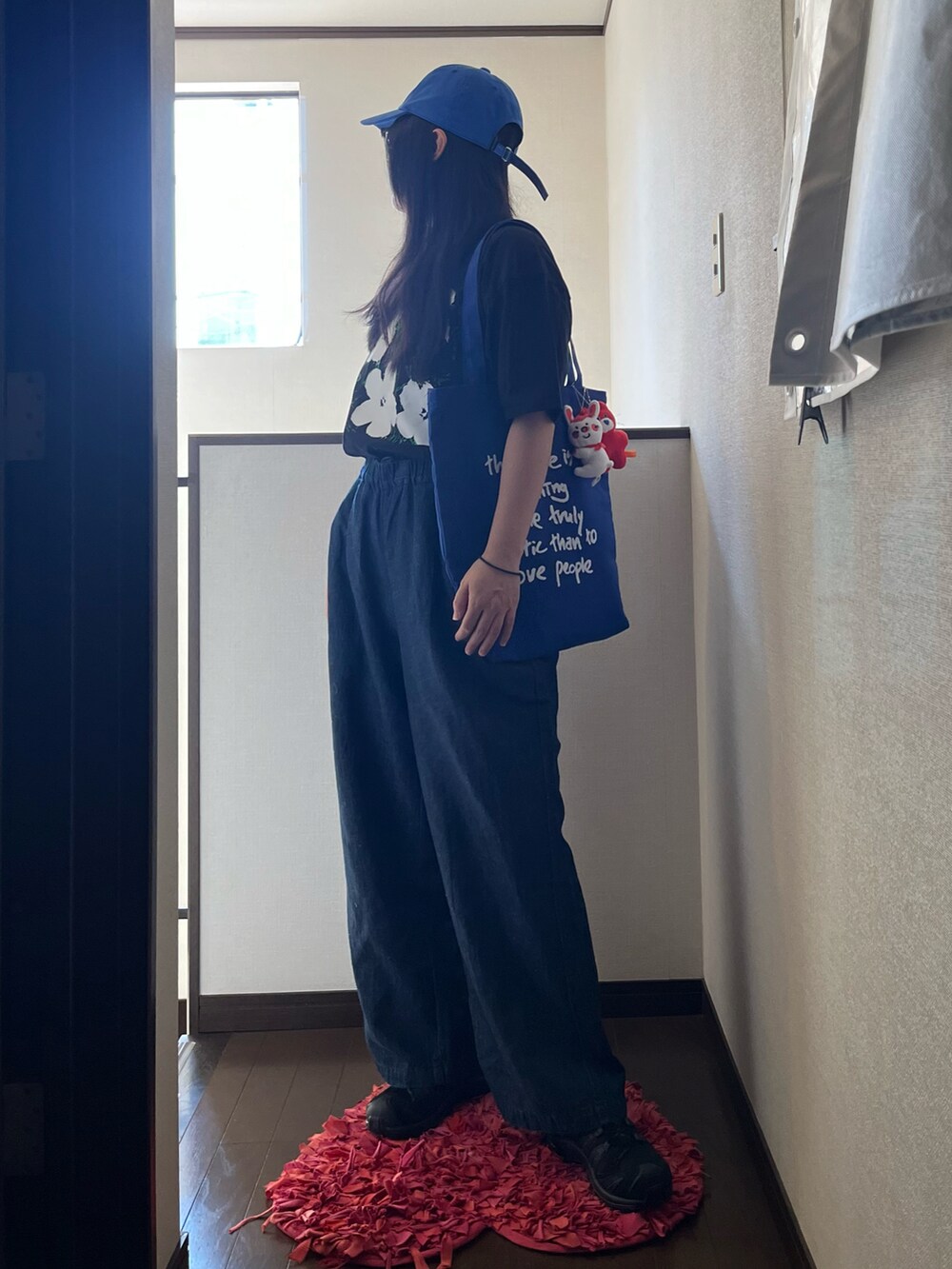 ブラック系のスニーカー、ブルー系のその他パンツ、ブラック系のTシャツ/カットソーを着用したレディースの夏コーディネートの3枚目の写真