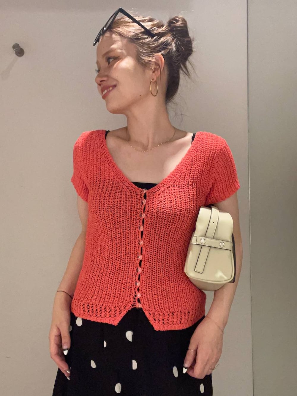 ブラック系のその他パンツ、オレンジ系のカーディガン/ボレロ、ブラック系のキャミソールを着用したレディースの夏コーディネートの2枚目の写真