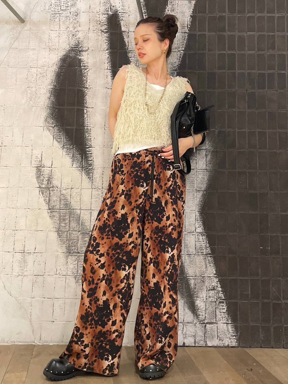 ブラック系のボストンバッグ、ホワイト系のタンクトップ、ブラック系のサンダルを着用したレディースの夏コーディネートの8枚目の写真