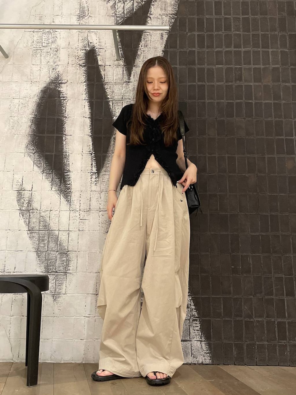 ベージュ系のその他パンツ、ブラック系のショルダーバッグ、ブラック系のサンダルを着用したレディースの夏コーディネートの4枚目の写真