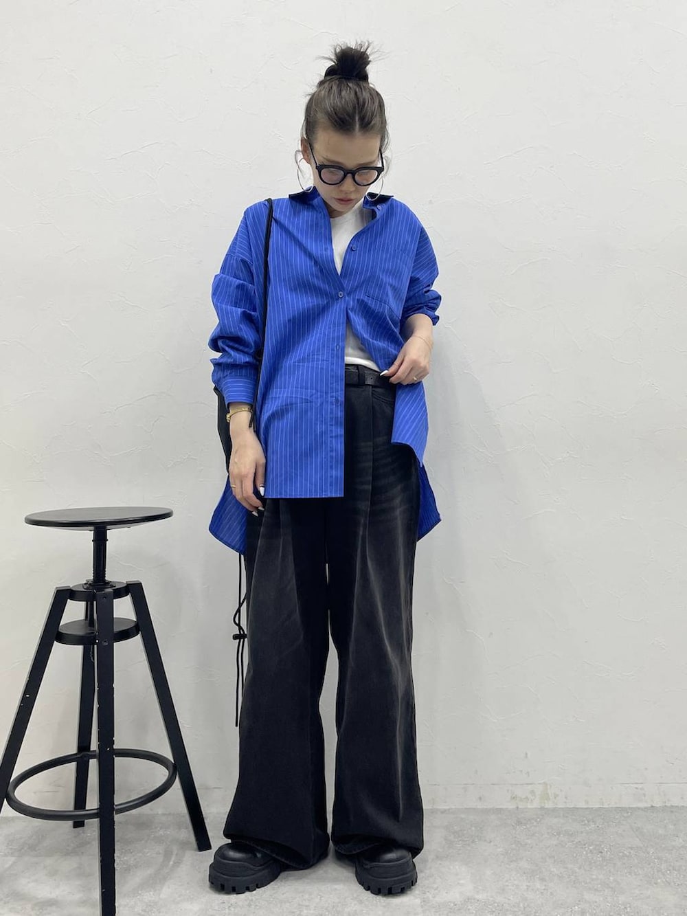 グレー系のデニムパンツ、ブラック系のブーツ、ブラック系のバックパック/リュックを着用したレディースの冬コーディネートの4枚目の写真