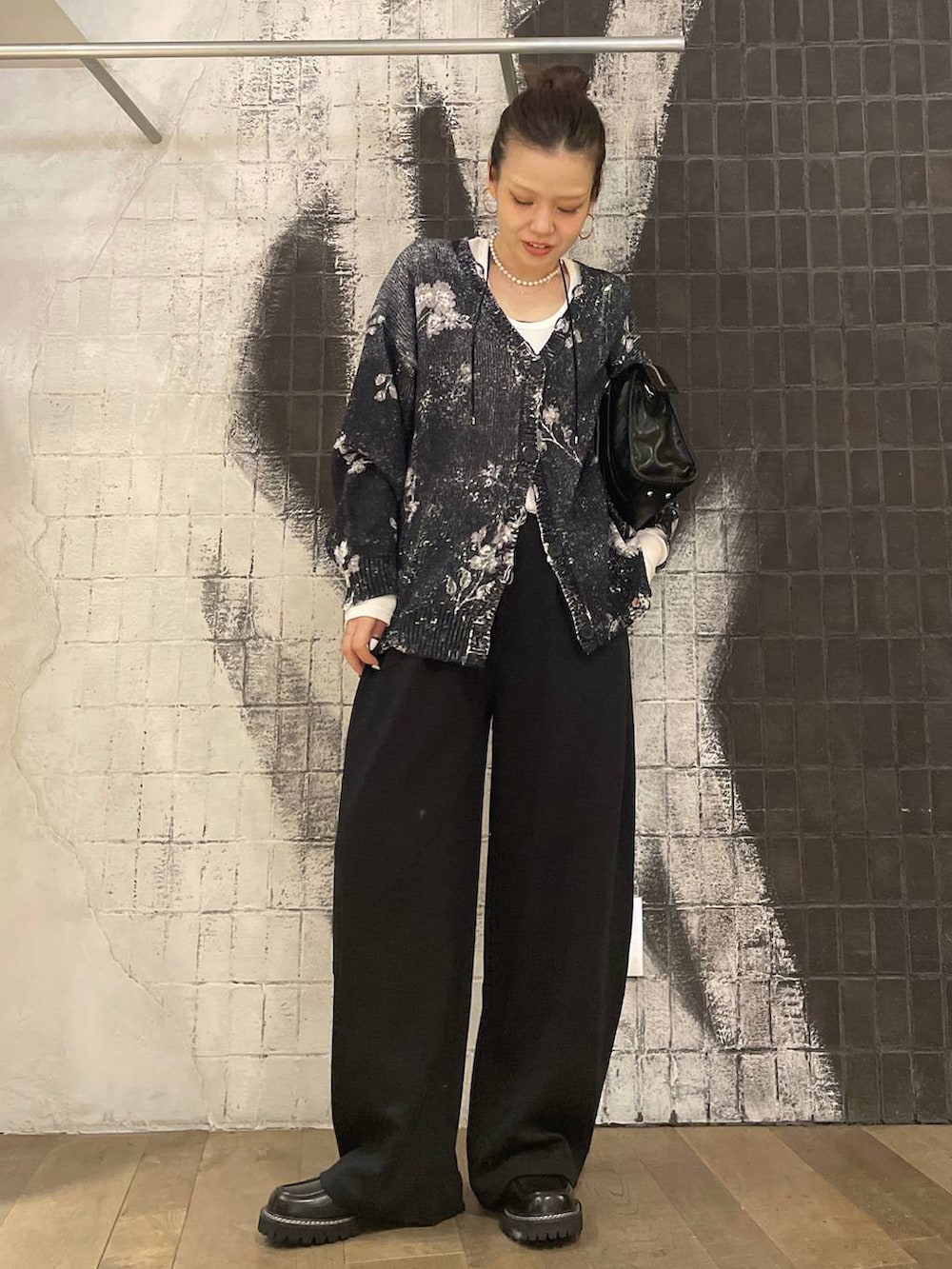 ホワイト系のTシャツ/カットソー、ブラック系のボストンバッグ、ブラック系のスラックスを着用したレディースの秋コーディネートの2枚目の写真