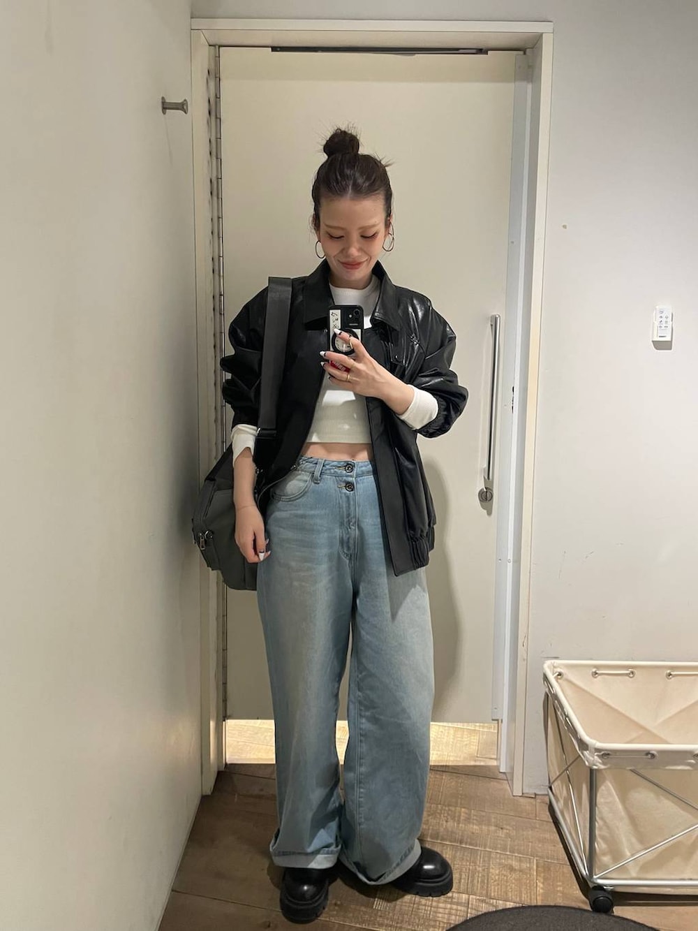 グリーン系のトートバッグ、ブルー系のデニムパンツ、ホワイト系のTシャツ/カットソーを着用したレディースの春コーディネートの5枚目の写真