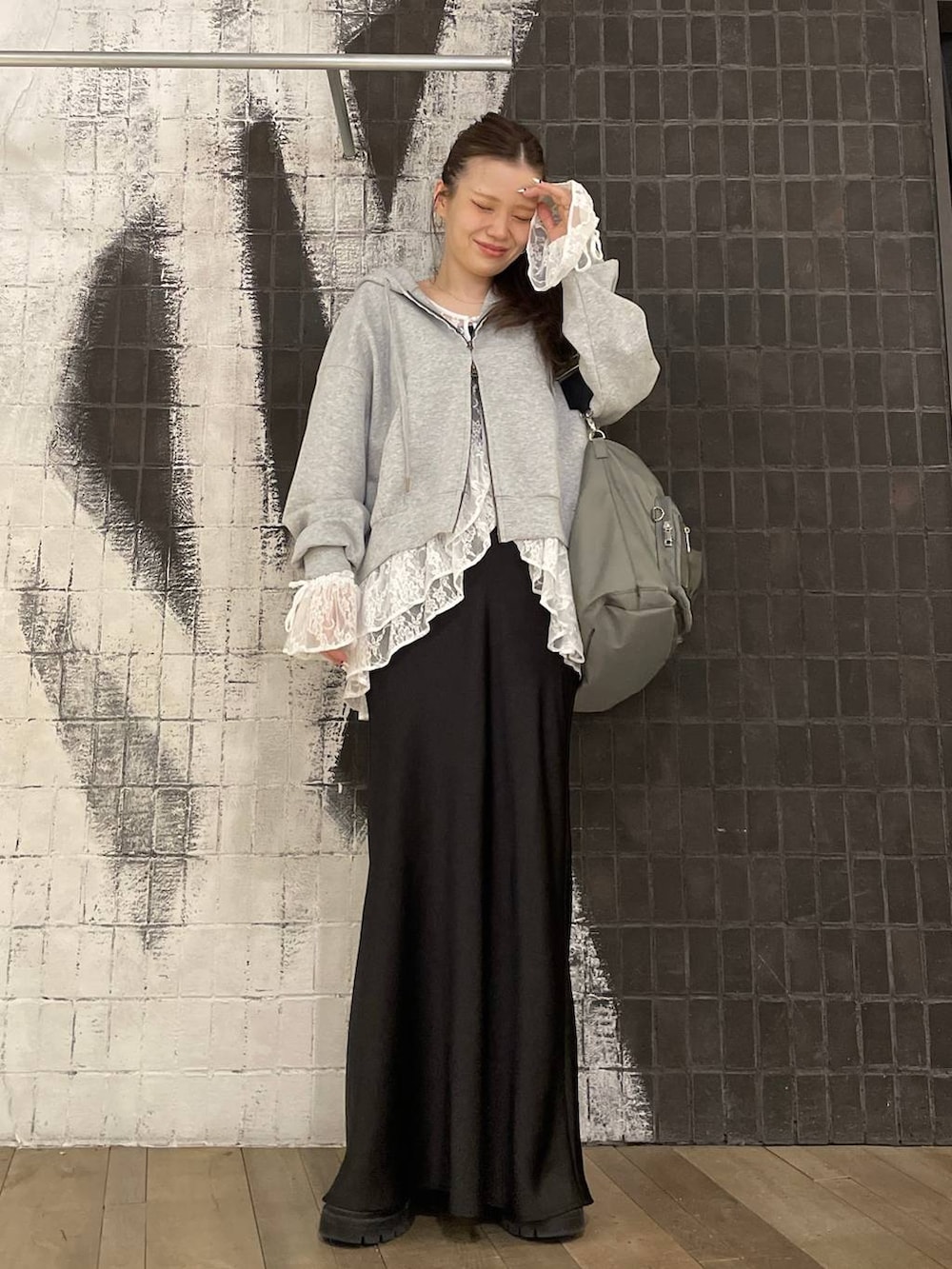 ホワイト系のシャツ/ブラウス、グリーン系のトートバッグ、ブラック系のスカートを着用したレディースの春コーディネートの3枚目の写真