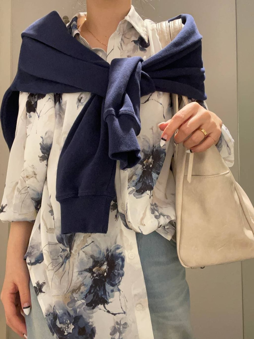 ホワイト系のトートバッグ、ホワイト系のドレスシューズ、ブルー系のスウェットを着用したレディースの春コーディネートの3枚目の写真