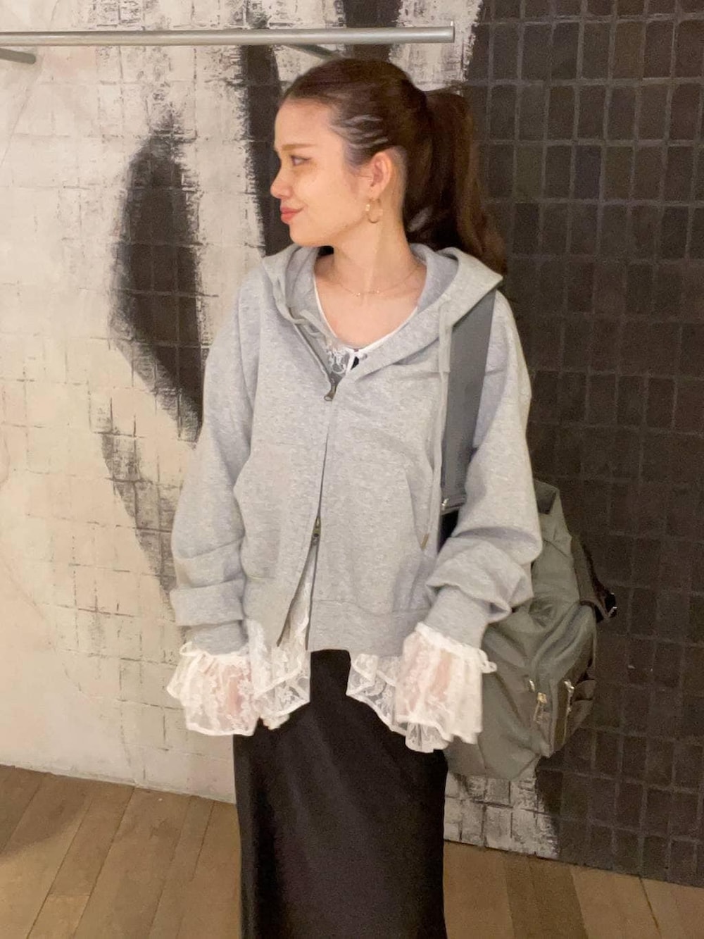 ホワイト系のシャツ/ブラウス、グリーン系のトートバッグ、ブラック系のスカートを着用したレディースの春コーディネートの2枚目の写真