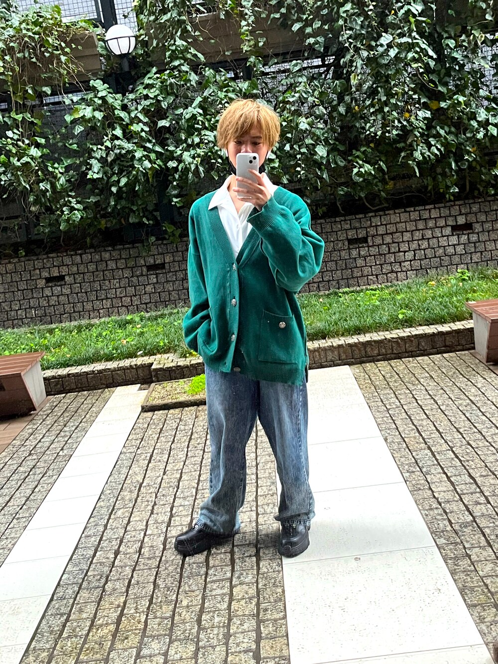 グリーン系のカーディガン/ボレロ、ホワイト系のシャツ/ブラウス、ブルー系のデニムパンツを着用したメンズの春コーディネートの3枚目の写真