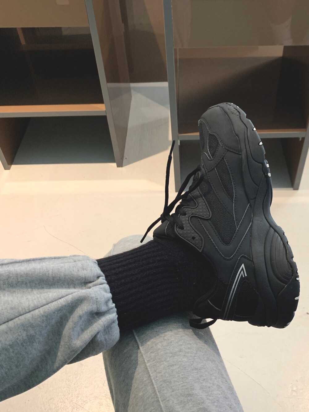 ホワイト系のスニーカーを着用したメンズの秋コーディネートの3枚目の写真