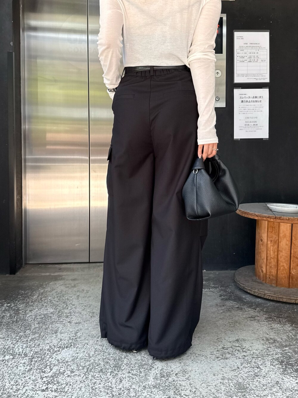 ホワイト系のTシャツ/カットソー、ブラック系のカーゴパンツ、ブラック系のショルダーバッグを着用したレディースの夏コーディネートの6枚目の写真