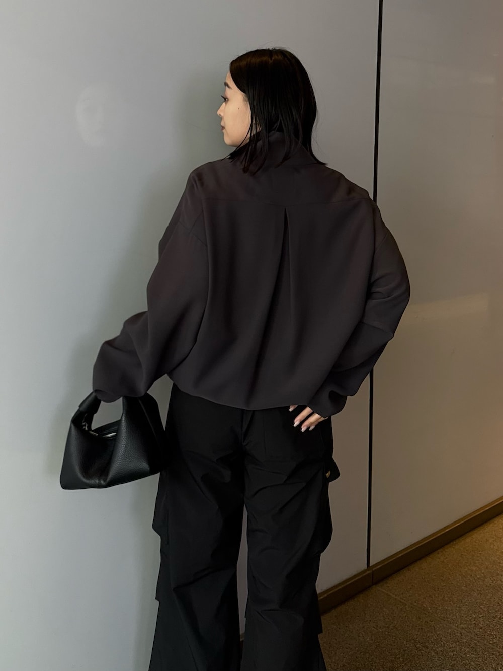 グレー系のシャツ/ブラウス、ブラック系のカーゴパンツ、ブラック系のショルダーバッグを着用したレディースの春コーディネートの3枚目の写真