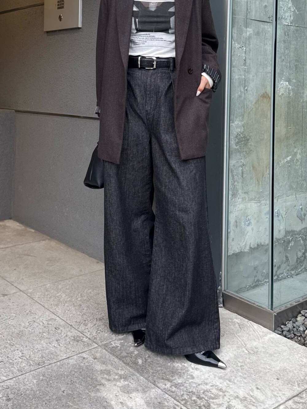 ブラウン系のテーラードジャケット、ホワイト系のTシャツ/カットソー、ブラック系のデニムパンツを着用したレディースの秋コーディネートの5枚目の写真