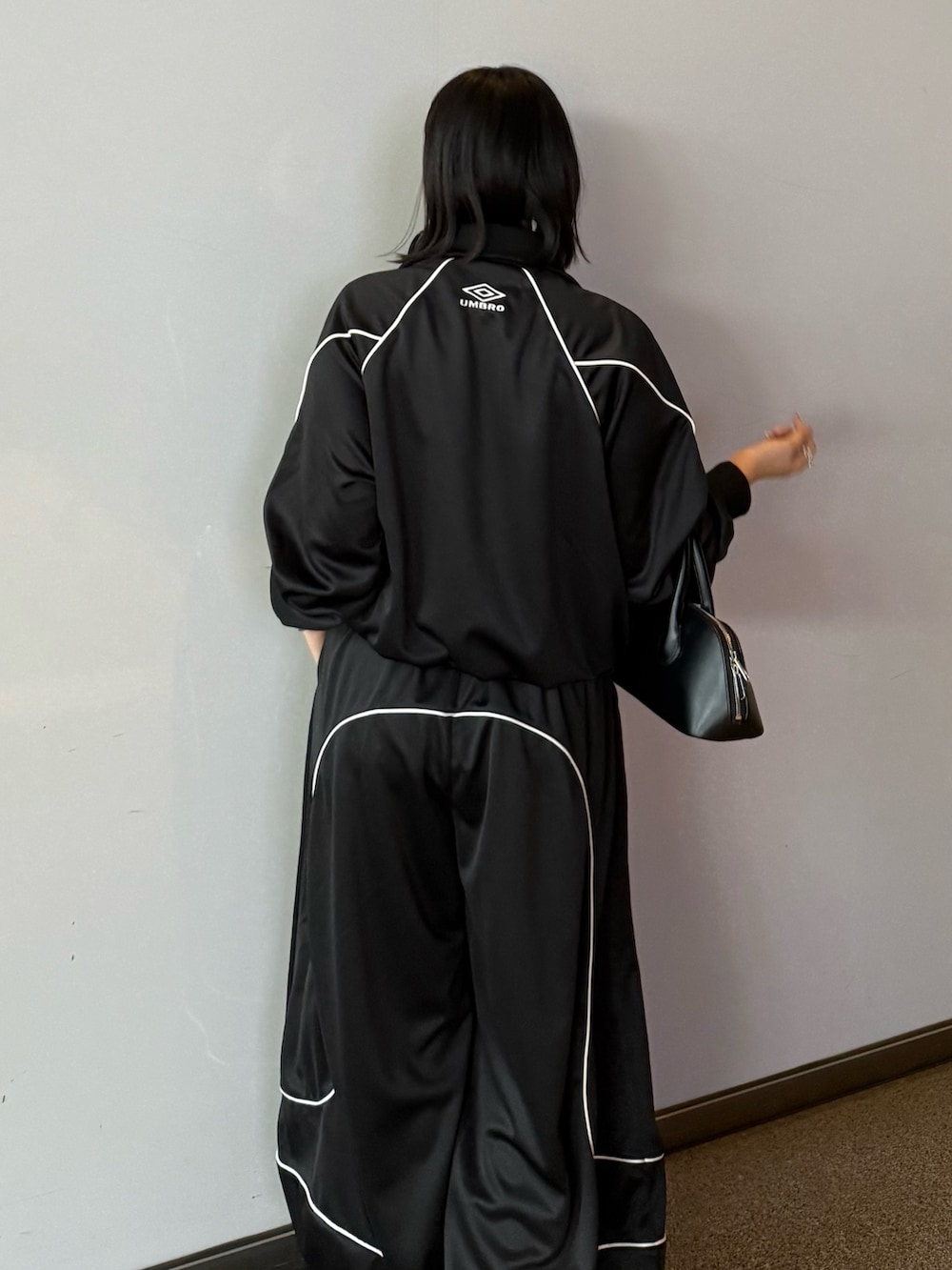 ブラック系のブルゾン、ブラック系のその他パンツ、ブラック系のショルダーバッグを着用したレディースの冬コーディネートの5枚目の写真